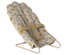 Load image into Gallery viewer, Floral-patterned baby bouncer with stand on a white background
