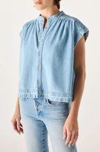 Load image into Gallery viewer, Light blue denim shirt worn by a person on a white background