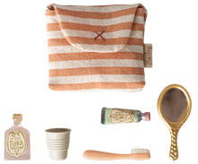 Load image into Gallery viewer, Set of beauty products including a striped bag, bottle, cup, brush, and mirror on a white background.