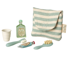 Load image into Gallery viewer, Set of children's dental care items including a cup, toothbrush, and toothpaste with a striped pouch on a white background.