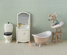 Load image into Gallery viewer, Miniature bathroom set with bathtub, toilet, and vanity against a patterned wall.