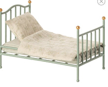 Load image into Gallery viewer, Green metal bed with beige bedding on a white background