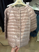 Load image into Gallery viewer, Pink puffer jacket on a hanger with a visible brand label.
