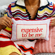 Load image into Gallery viewer, Person holding a pillow with 'expensive to be me' text, wearing a colorful sweater.