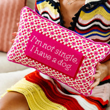 Load image into Gallery viewer, Person holding a pink pillow with a checkered pattern and text 'I'm not single, I have a dog'.